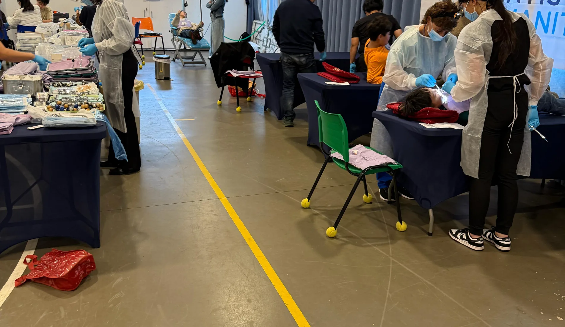 Volunteer dentists treating patients at a pop-up Dentists for Humanity clinic in Paraguay