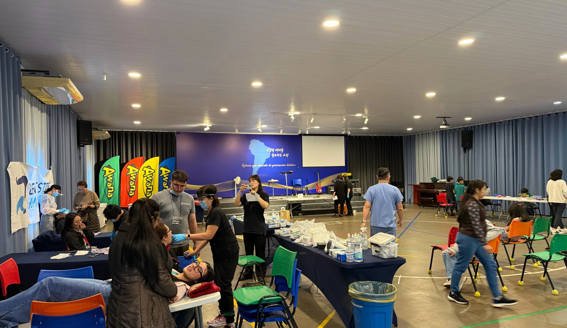 The volunteer dental team examines patients in a community hall during the Paraguay humanitarian mission