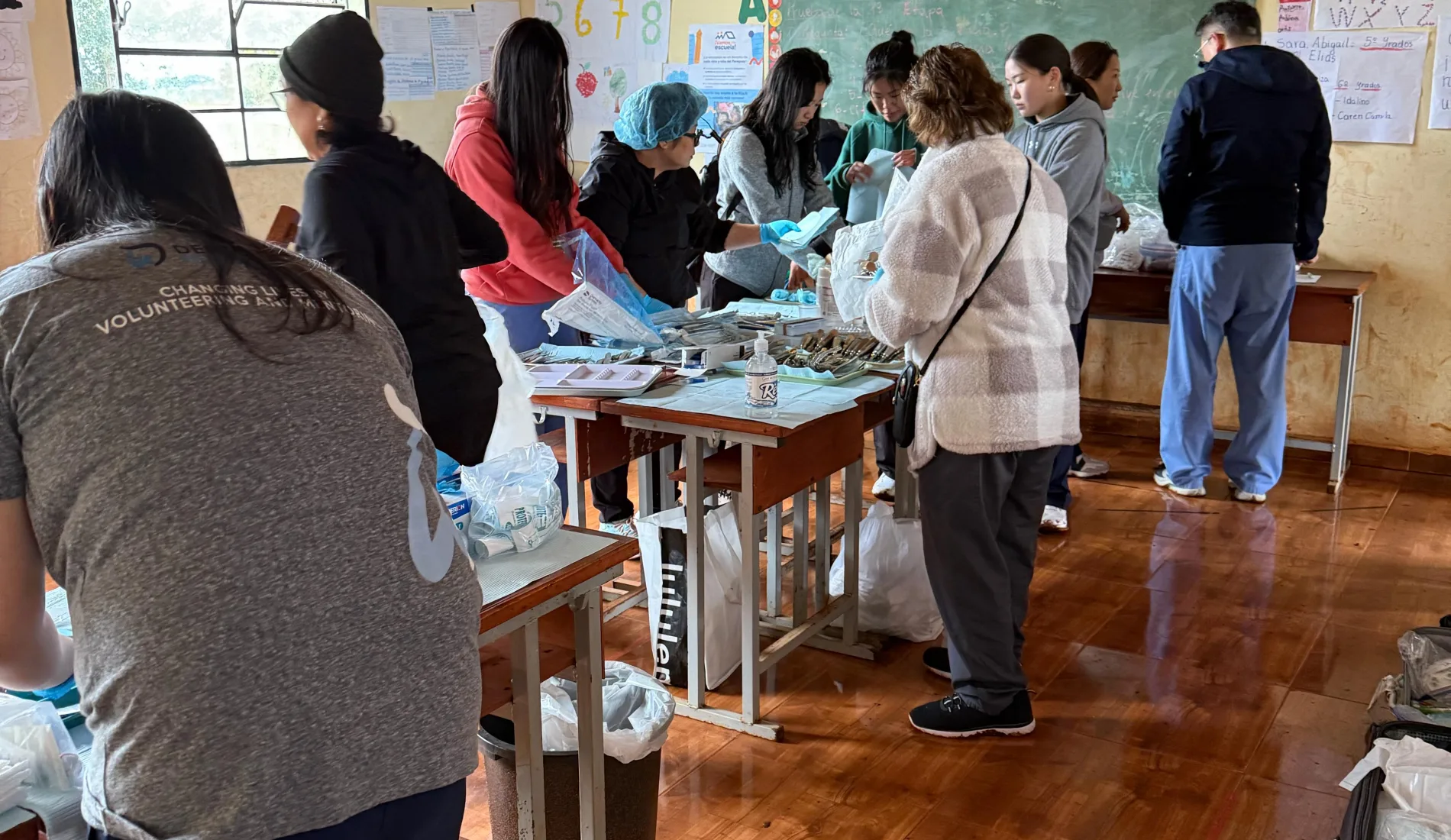 Volunteers organize dental supplies in a village school classroom during the Paraguay mission