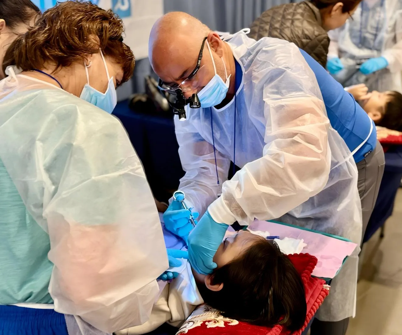 Dr. Salha provides free dental care to a young patient during the humanitarian mission in Paraguay